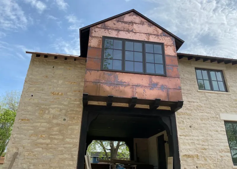 Copper metal panel facade on a stone building for Metal Roof Coating in Jaffrey